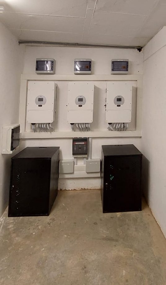 Three Deye hybrid inverters and two battery cabinets in the plant room